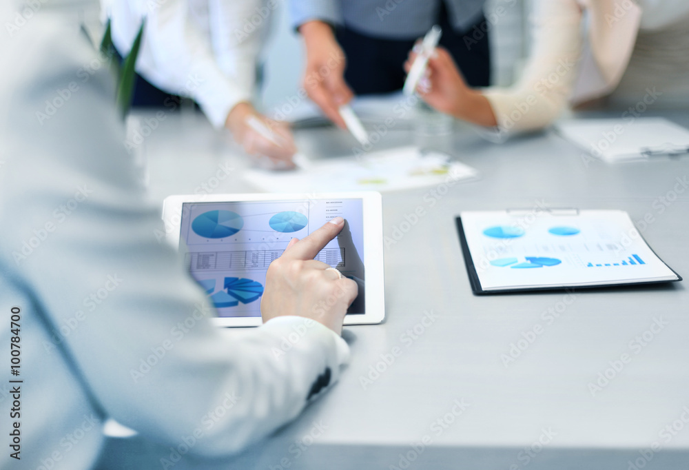 Cropped shot of a group of businesspeople looking at graphs on digital tablets