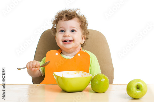little child eats with spoo...