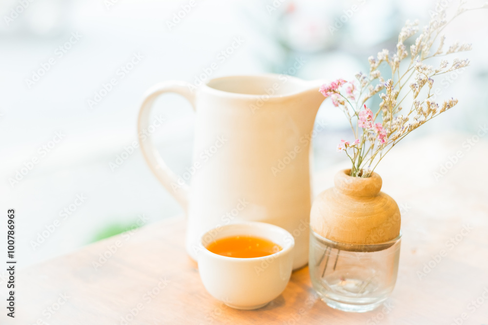 Cup of hot tea on wooden table , soft focus