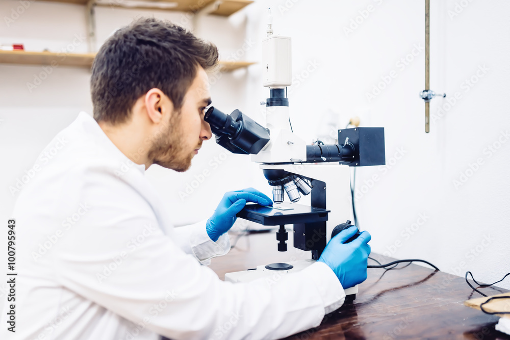 man, male scientist, chemist working with microscope in pharmaceutical laboratory, examining samples man, male scientist, chemist working with microscope in pharmaceutical laboratory, examining samples