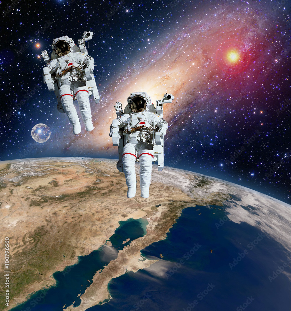 Fototapeta premium Two astronauts spaceman planet spacewalk outer space walk moon milky way galaxy. Elements of this image furnished by NASA.