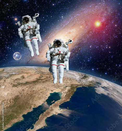 Fototapeta Naklejka Na Ścianę i Meble -  Two astronauts spaceman planet spacewalk outer space walk moon milky way galaxy. Elements of this image furnished by NASA.
