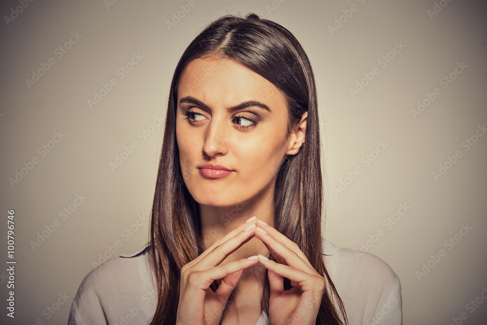sneaky, sly, scheming young woman plotting something sneaky, sly, scheming young woman plotting something