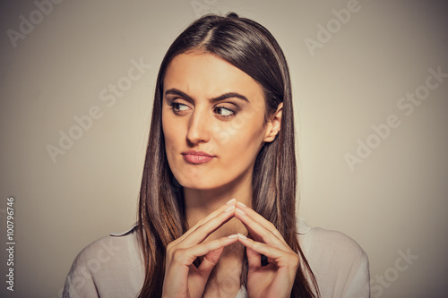 Canvas Print sneaky, sly, scheming young woman plotting something