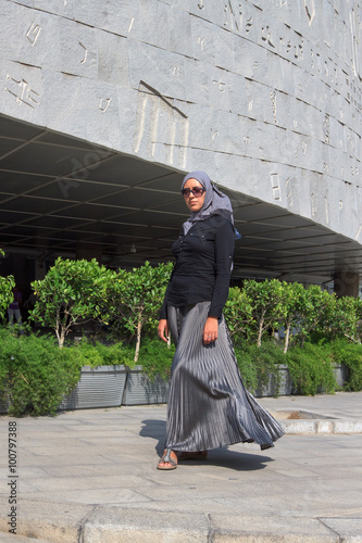 Student walking along entrance of Alexandria Library in Egypt