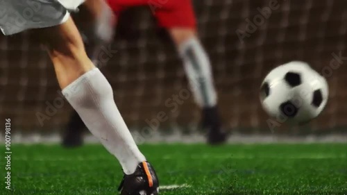 Close up of a soccer player making penalty kick into the goal