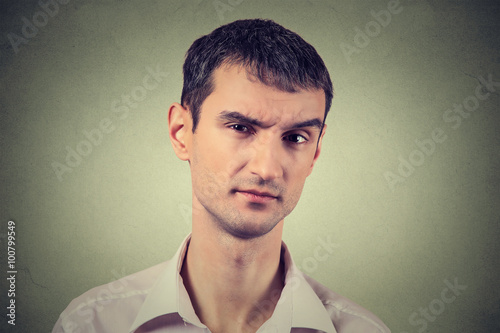 Fotografía skeptical man looking suspicious, some disgust on his face
