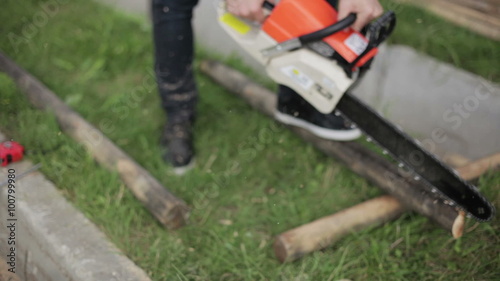 Wallpaper Mural man saws off a piece of timber Torontodigital.ca