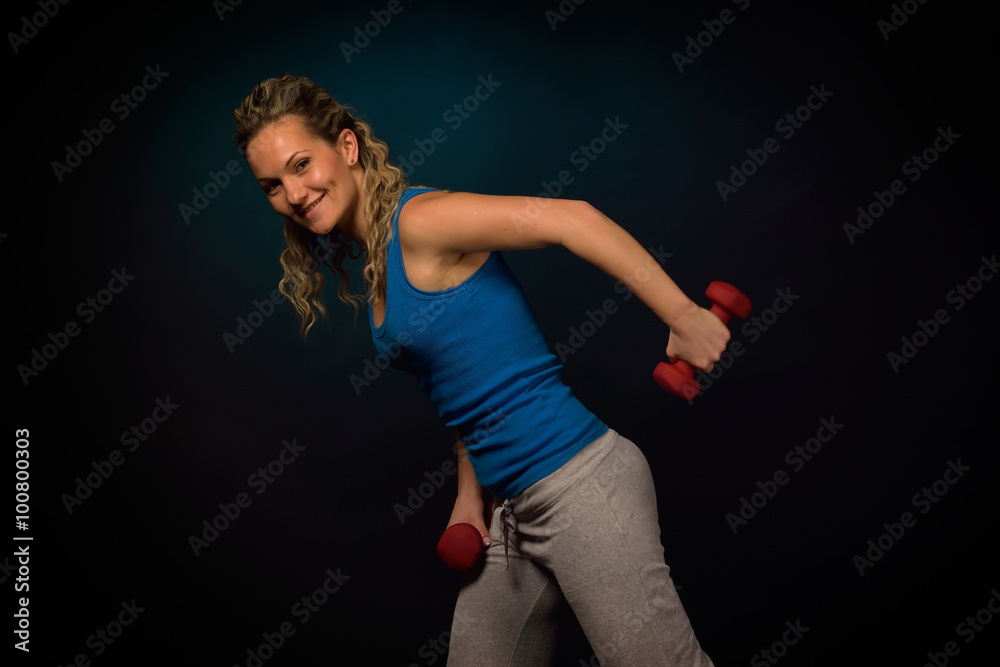 young woman exercising in the gym