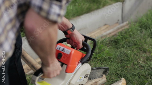 Wallpaper Mural man works chainsaw close-up Torontodigital.ca