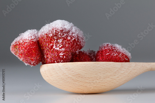 Frozen strawberry in spoon