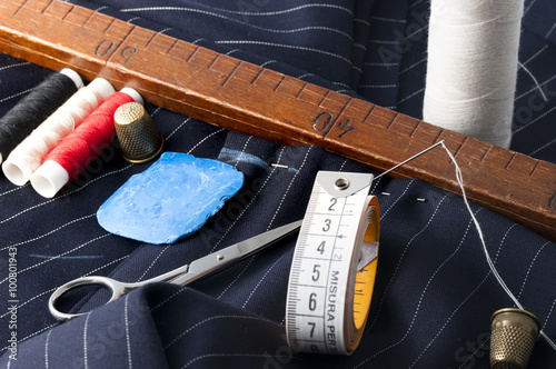 view of a tailored suit from a tailor in his study, with needle, thread, chalk