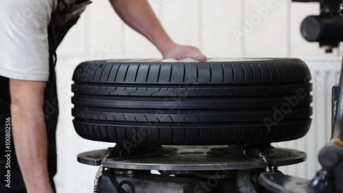 Car mechanic removes the tire from the rim