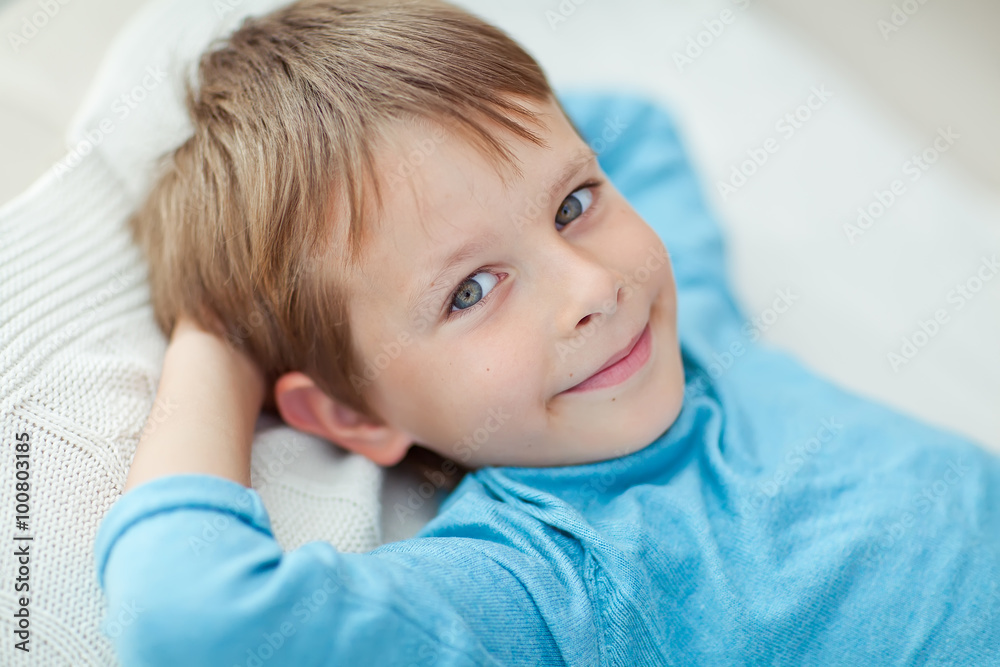 Happy kid are lying in the bed 