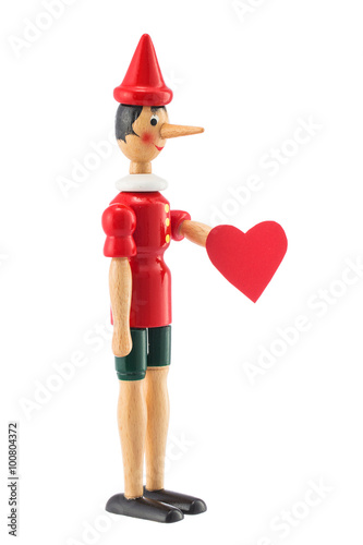 Fototapeta Pinocchio toy statue with heart isolated on white