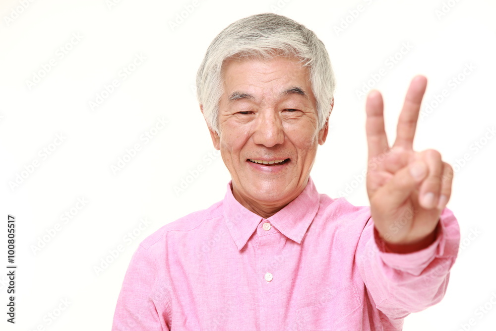 senior Japanese man showing a victory sign senior Japanese man showing a victory sign