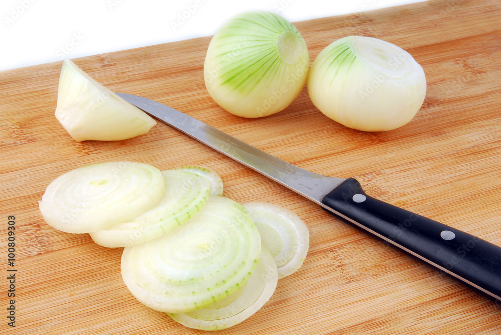 onion slices and knife on wooden board onion slices and knife on wooden board