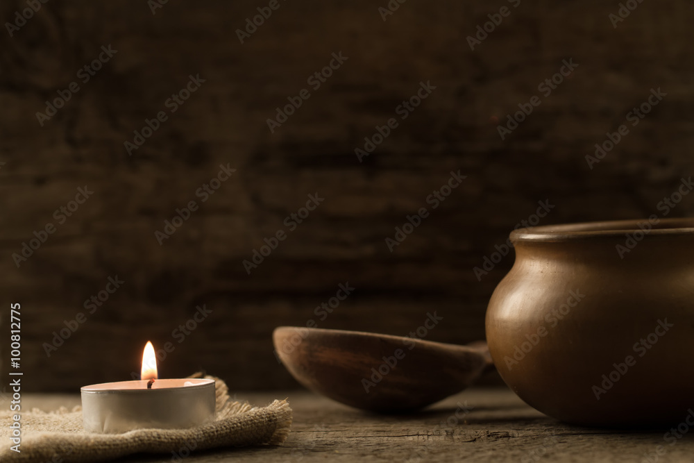 Fototapeta premium light burning brightly candles on old wooden background. Spa, meditation, ritual, flavored.
