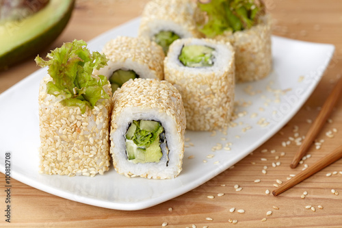 California vegetarian sushi roll with avocado, cucumber and salad.