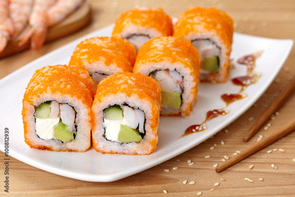 Philadelphia sushi roll with shrimp, avocado, cream cheese, cucumber and tobiko caviar. Philadelphia sushi roll with shrimp, avocado, cream cheese, cucumber and tobiko caviar.