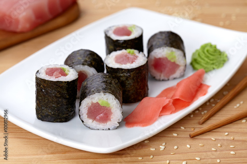 Maki sushi roll with tuna, wasabi, ginger and nori seaweed.