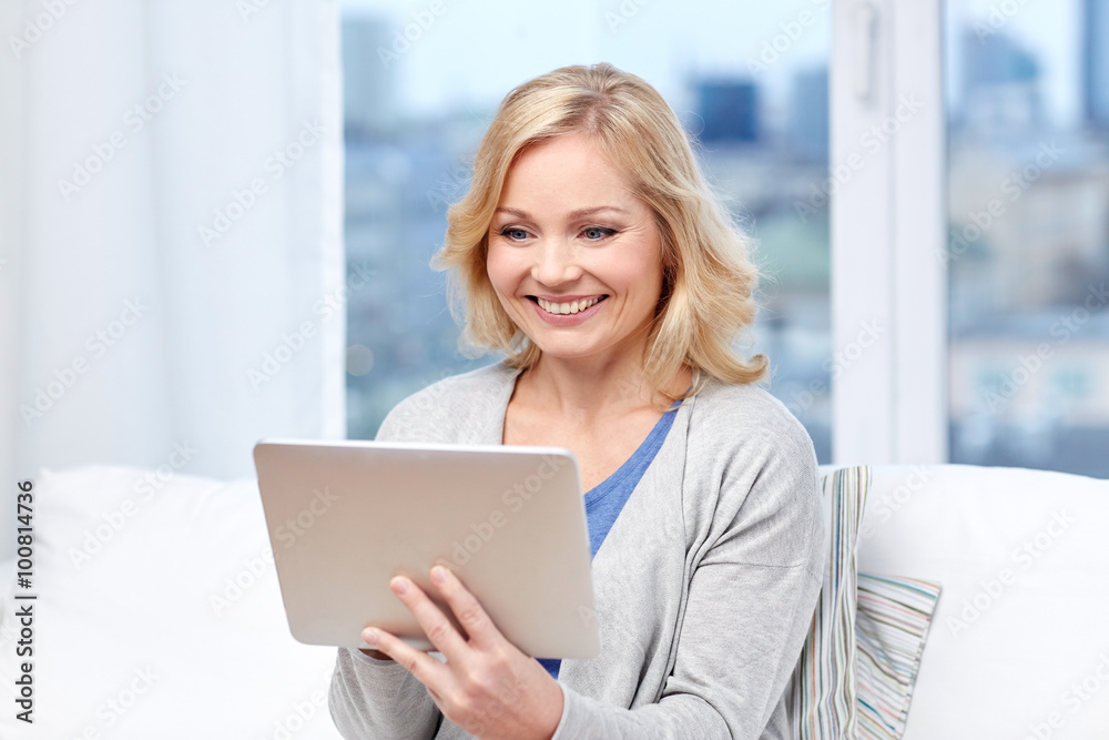 happy middle aged woman with tablet pc at home happy middle aged woman with tablet pc at home