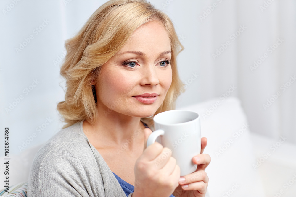 smiling woman with cup of tea or coffee at home smiling woman with cup of tea or coffee at home