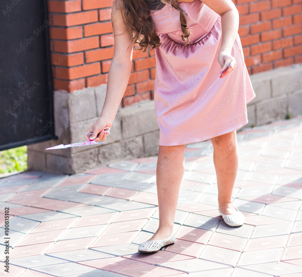 Beautiful woman holding an arrow pointing to her left side Beautiful woman holding an arrow pointing to her left side