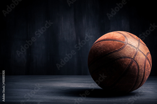 Old basketball ball on a black background © BortN66