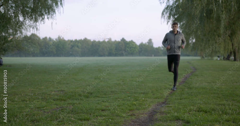 Man running at morning in park, taking short break and run away. Slow motion
Man running at morning in park, taking short break and run away. Slow motion