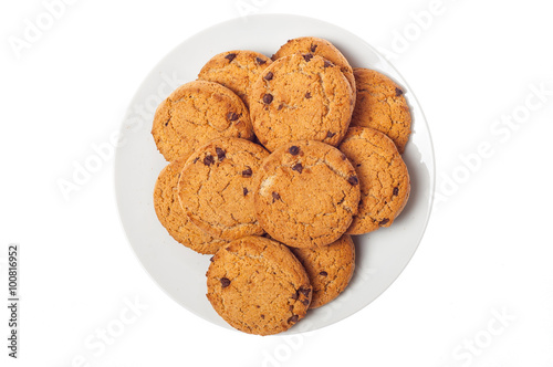 Oat cookies in plate isolated on white background, top view