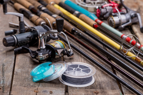 fishing rods and reels on wooden boards