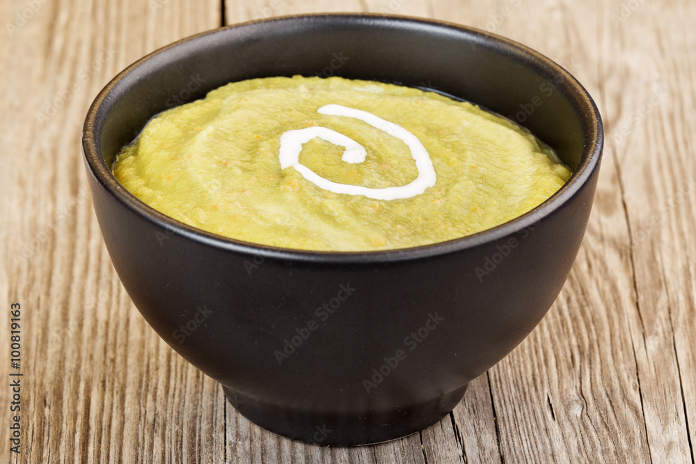 vegetable mash in black bowl on wooden table vegetable mash in black bowl on wooden table