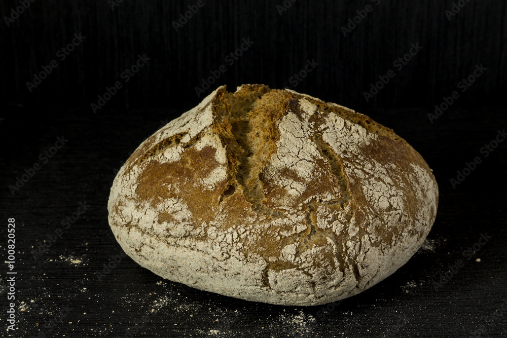 Wheat bread. Black background. Wheat bread. Black background.