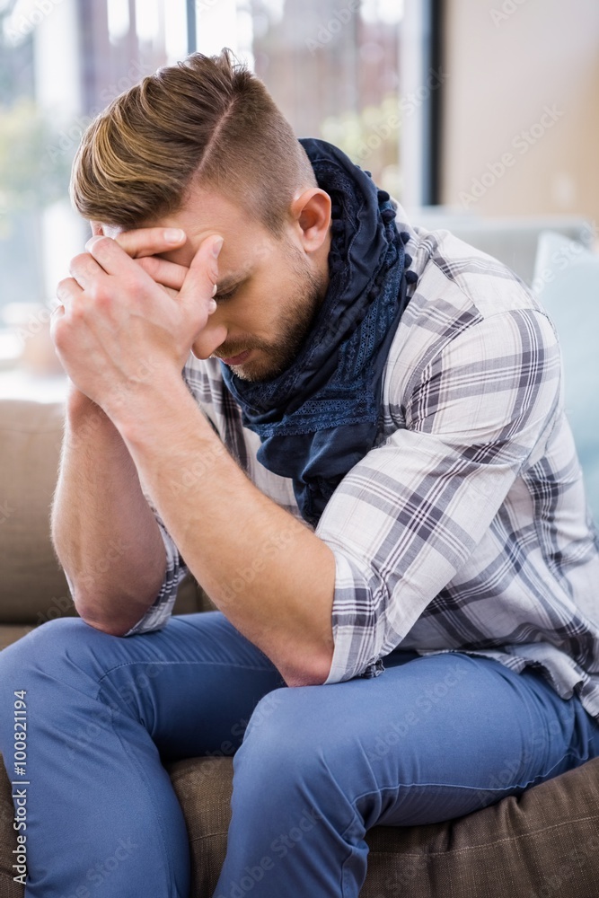 Worried man thinking on the couch Worried man thinking on the couch
