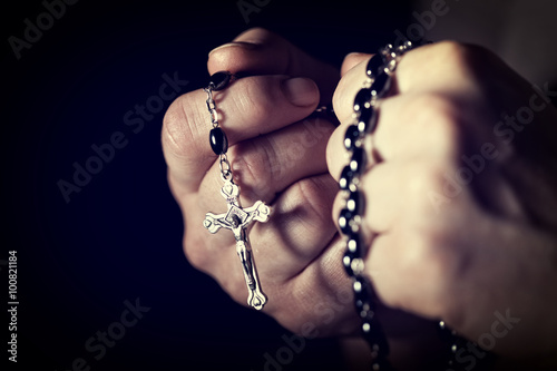 Fotografie, Obraz Caucasian person's hands tighten a Christian rosary for prayer