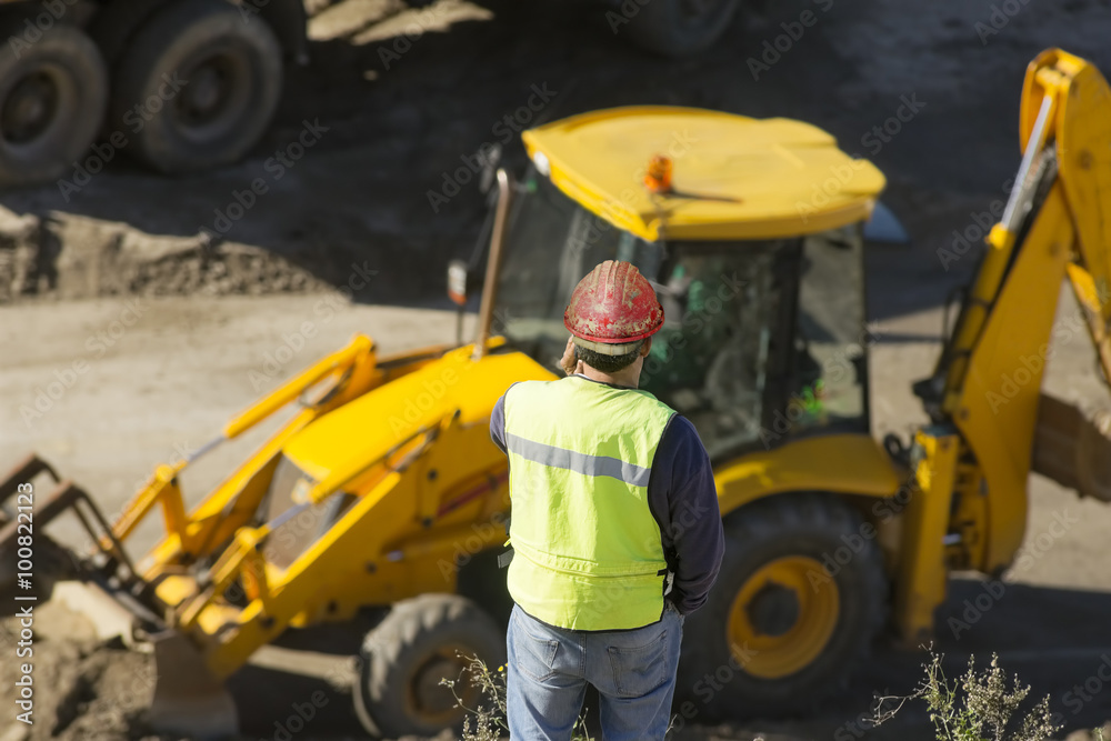 engineer foreman in highway construction site with excavators selective focus 