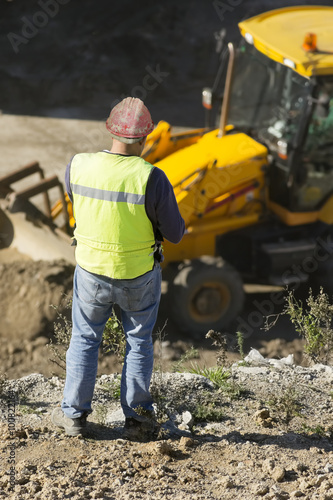 engineer foreman in highway construction site with excavators selective focus 