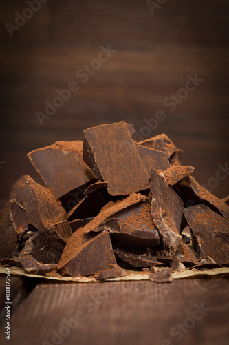 Dark chocolate with cacao on wooden table