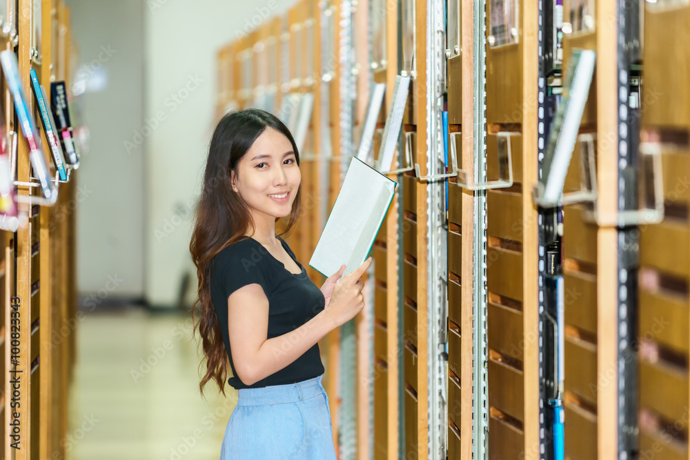Asia Portrait of a smiling woman in a library Asia Portrait of a smiling woman in a library