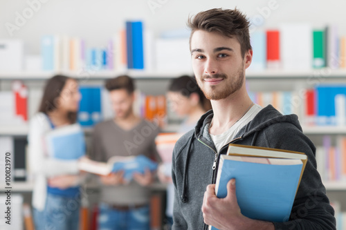 Obraz na plátně Confident student posing in the library