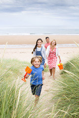 Family walking up the sand dunes