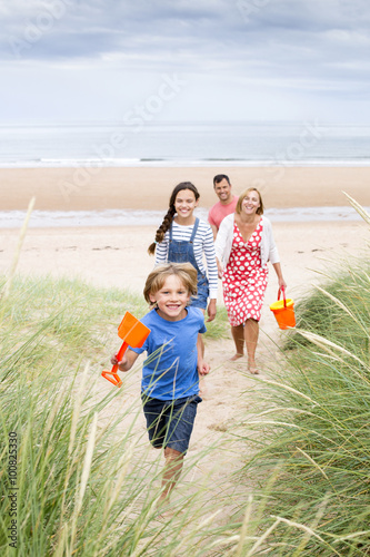 Family walking up the sand dunes