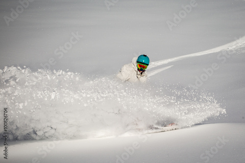 Man snowboarding on snow in the mountains
