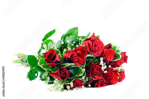 A bunch of Red Roses and green leaves, together with gypsophila tied in a bouquet against white background
