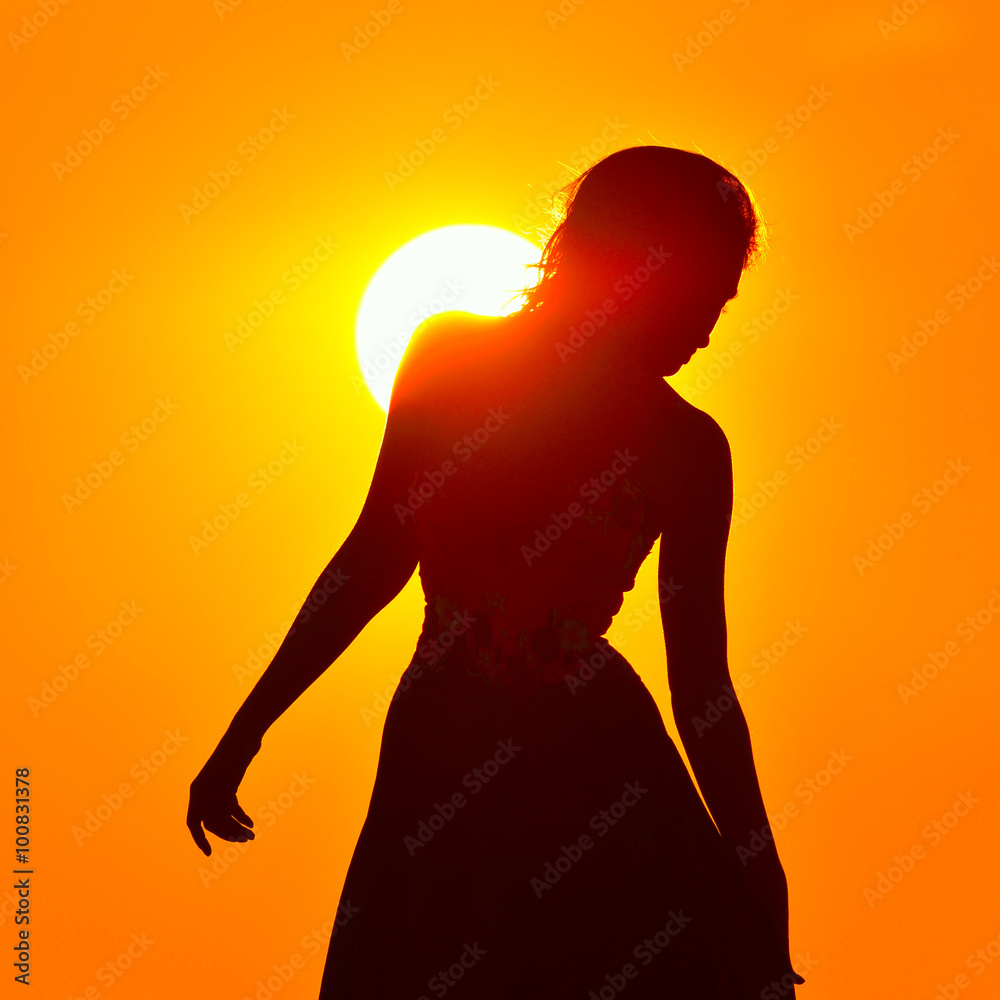 young woman silhouette at sunset