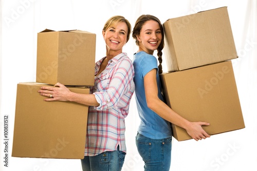 Mother and daughter holding boxes