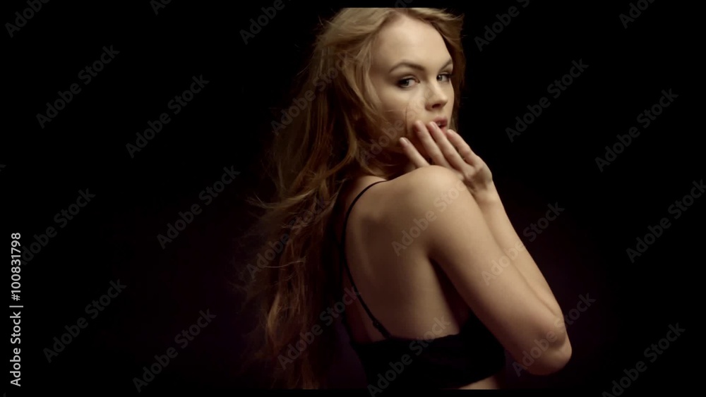 Cute lady in a black bikini having fun laughing and throwing her arms Cute lady in a black bikini having fun laughing and throwing her arms