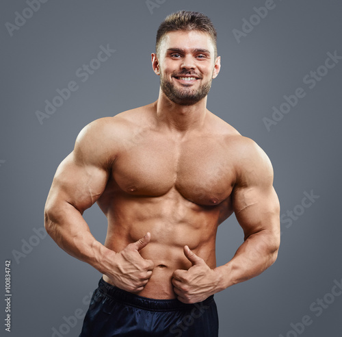 Smiling handsome man with muscular torso
