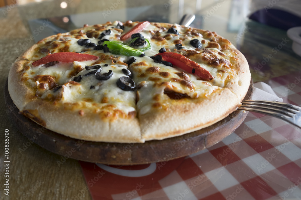Fresh pizza put on table inside restaurant Fresh pizza put on table inside restaurant